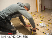 The process of laying floor tiles on the SVP Base, Tile Leveling System. Стоковое фото, фотограф Evgenii Predibailo / Фотобанк Лори