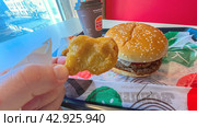Moscow April 10 2024, Big burger with two patties on a tray in burger king. Burger on a tray in fast food restaurant close-up. Fast food restaurant and self-service checkouts. Редакционное фото, фотограф Скрипачев Антон / Фотобанк Лори