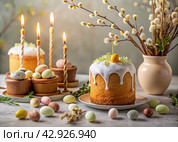 Orthodox Easter. Easter cake, painted eggs, icons, faces of saints, flowers, church candles and Easter decor on a wooden table in an old village house. Стоковое AI-изображение, AI-художник Photojuli / Фотобанк Лори