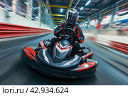 a male kart racer drives quickly along the autodrome track, blurred background. Стоковое AI-изображение, AI-художник Александр Довянский / Фотобанк Лори