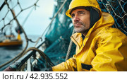 an elderly man fisherman in a yellow jacket on an industrial fishing boat against the background of nets and a fishing trawl. Стоковое AI-изображение, AI-художник Александр Довянский / Фотобанк Лори