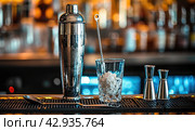 barware on the bar counter close-up, shaker, jigger, glass. Стоковое AI-изображение, AI-художник Александр Довянский / Фотобанк Лори