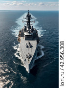 Aerial top view of modern warship sailing in still water at blue sky, mission military control of sea. Battleship on protection of water state borders. Naval forces army concept. Copy ad text space. Стоковое AI-изображение, AI-художник Aleksandr Golubev / Фотобанк Лори