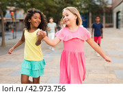 Two young girls walking hand in hand. Стоковое фото, фотограф Яков Филимонов / Фотобанк Лори