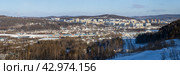 Город Тында, Амурская область, Россия. Зимний панорамный городской пейзаж. Вдали жилые дома и сопки. На среднем плане железная дорога (Тында находится на пересечении Байкало-Амурской магистрали и Амуро-Якутской железнодорожной магистрали). На переднем плане федеральная автомобильная дорога «Лена». Стоковое фото, фотограф Андрей Степанов / Фотобанк Лори