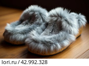 Comfortable Pair of grey slippers on floor. Generate Ai. Стоковое AI-изображение, AI-художник Иван Рябоконь / Фотобанк Лори