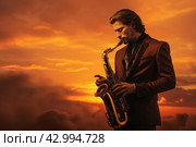 Melodic Saxophonist sunset play. Generate Ai. Стоковое AI-изображение, AI-художник Иван Рябоконь / Фотобанк Лори