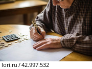 Budget-conscious Pensioner managing finances. Generate Ai. Стоковое AI-изображение, AI-художник Иван Рябоконь / Фотобанк Лори