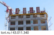 Moscow March 22 2024, Construction site with tower crane. House and buildings construction. Hotel apartments construction. Housing renovation, real estate. Crane on formwork in Built environment. Редакционное фото, фотограф Скрипачев Антон / Фотобанк Лори