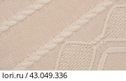 Soft Knitted Woolen Detailed Texture. Natural Fabric Closeup Knit Pattern. Beige Knitwear, Warm Cashmere Surface. Rotation, Macro. Cozy Creamy Textile Background. Clothes Production. Melange Yarn. 4K. Стоковое видео, видеограф Марина Демидюк / Фотобанк Лори