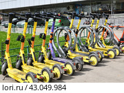 Moscow, Russia - Apr 26. 2024. Short-term rental service for electric scooters Yandex Go and Urent in Zelenograd. Редакционное фото, фотограф Володина Ольга / Фотобанк Лори
