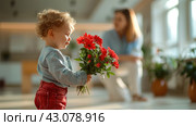 Adorable Toddler Surprising Mother with Bouquet of Red Flowers Indoors, ai-generated item. Стоковое AI-изображение, AI-художник Юлия Паутова / Фотобанк Лори