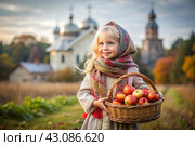 The concept of the Russian Orthodox holiday yablochny spas. A beautiful little girl in Russian national clothes and a headscarf with a basket of red ripe apples on the background of an Orthodox church. Стоковое AI-изображение, AI-художник Photojuli / Фотобанк Лори