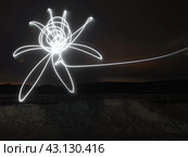 Lights drawing. Light vortex. Winter black night in countyside as a background. Silhouette of a flower. Abstract concepts. Bright fire lines. The lighting usage. Стоковое фото, фотограф YuryKara / Фотобанк Лори