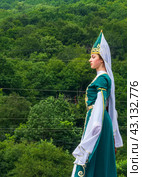 Adygea, RUSSIA - JULY 25 2015: A young Circassian girl in a beautiful national costume on the background of a green forest. Редакционное фото, фотограф Андрей С / Фотобанк Лори