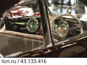 Classic luxury interior of a retro Alfa Romeo car and a close-up steering wheel. Russia, May 11, 2024. Редакционное фото, фотограф Photojuli / Фотобанк Лори