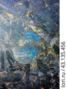 Фон и текстура полевого шпата с иризацией, минералогия, геология, наука./ Macro texture blue glowing labradorite gemstone closeup. Стоковое фото, фотограф Iva Noel / Фотобанк Лори