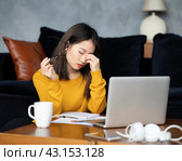 Asian woman working at home, writing notebook. Beautiful Japanese female freelancer. Стоковое фото, фотограф Natalia Gdovskaia / Фотобанк Лори