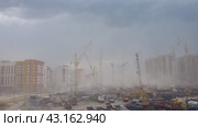 Bad weather with strong wind and dust in the area of ​​new buildings under construction. Редакционное видео, видеограф Дмитрий Кобзев / Фотобанк Лори