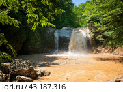 View of the waterfall Noise of the waterfall cascade of the Rufabgo creek on a sunny summer day, Kamennomostsky, Republic of Adygea, Russia. Стоковое фото, фотограф Ula Ulachka / Фотобанк Лори