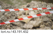 Red white barrier tape trenches. Focus on red and white barrier tape at construction site. Ribbons indicate dug trenches. Стоковое видео, видеограф svetograph / Фотобанк Лори