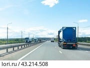 Petrol cargo truck driving on highway hauling oil products. Fuel delivery transportation and logistics concept on a sunny summer evening. Compressed gas carrier truck rear view on a highway. Стоковое фото, фотограф Ирина Михайличенко / Фотобанк Лори