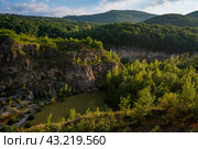View of Lake Krasnoe in an abandoned gypsum quarry in the vicinity of Khadjokh on a sunny summer day, Kamennomostsky village, Republic of Adygea, Russia. Стоковое фото, фотограф Ula Ulachka / Фотобанк Лори