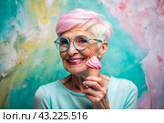 Portrait of an extraordinary, stylish, fashionable elderly woman, a pensioner of 70 years old, with glasses and ice cream in her hand. The concept of happy seniors and delicious desserts. Стоковое AI-изображение, AI-художник Photojuli / Фотобанк Лори