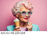 Portrait of an extraordinary, stylish, fashionable elderly woman, a pensioner of 70 years old, with glasses and ice cream in her hand. The concept of happy seniors and delicious desserts. Стоковое AI-изображение, AI-художник Photojuli / Фотобанк Лори