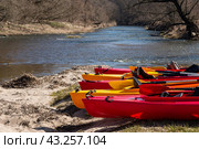 Kayak on the river bank. Active pastime of the weekend. Sports tourism. Kayak rafting in the spring. Kayaks made of yellow and red plastic. Стоковое фото, фотограф Zima Nadezhda / Фотобанк Лори