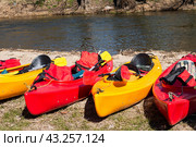 Kayak on the river bank. Active pastime of the weekend. Sports tourism. Kayak rafting in the spring. Kayaks made of yellow and red plastic. Стоковое фото, фотограф Zima Nadezhda / Фотобанк Лори