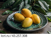 Close-up of fresh mangoes. Delicious berries and fruits are bright yellow in color with drops of water. Vegetarianism. Healthy eating. Fresh fruits on the table. Стоковое AI-изображение, AI-художник Photojuli / Фотобанк Лори