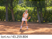A woman is playing tennis on a court. Стоковое фото, фотограф Константин Шишкин / Фотобанк Лори