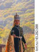 Dakhovskaya, Russia - September 22,  2018: portrait a young girl in traditional Circassian clothes dances at the festival of Adyghe cheese in the foothills of the Caucasus. Редакционное фото, фотограф Андрей С / Фотобанк Лори