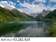 View of Lake Tumanly-Gel (Foggy Lake) in the valley of the Gonachkhir River on the territory of the Teberdinsky National Park on a sunny summer day, Dombay, Karachay-Cherkessia, Russia. Стоковое фото, фотограф Ula Ulachka / Фотобанк Лори