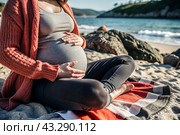 Relaxation, peace of mind, sea air. Close-up of the tummy. A pregnant woman on the beach by the sea. The concept of pregnancy, childbirth and parental responsibilities. Стоковое AI-изображение, AI-художник Photojuli / Фотобанк Лори