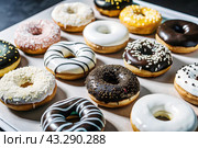 Delicious dessert. A sick box of different donuts with colorful sprinkles on the table. Confectionery products. Стоковое AI-изображение, AI-художник Photojuli / Фотобанк Лори