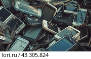 The huge number of outdated cell phones indicates the rapid spread of high-tech devices. Стоковое AI-изображение, AI-художник Ярославский Максим / Фотобанк Лори