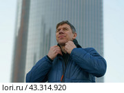 Портрет молодого мужчина на фоне офисного здания. Стоковое фото, фотограф YuryKara / Фотобанк Лори