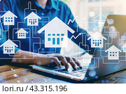 The user's personal laptop and hands on the keyboard with a home icon and a growth chart. The concept of investing in real estate. Стоковое AI-изображение, AI-художник Ярославский Максим / Фотобанк Лори
