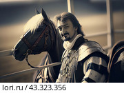 Knight in armor standing next to a horse. The knight has short dark hair and a beard, and a slight smile on his face. He is dressed in metal armor with decorations and holds a sword. The horse is also decorated with knightly equipment, including harness and bridle. The background is blurry, with a hint of a battle or tournament. The picture conveys the atmosphere of the Middle Ages and chivalry. Стоковое AI-изображение, AI-художник Анна Кривицкая / Фотобанк Лори