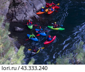 Adygea, Russia - October 10, 2017: a group of kayak athletes descends on kayaks along the Belaya mountain river in Adygea in the autumn, the top view. Редакционное фото, фотограф Андрей С / Фотобанк Лори