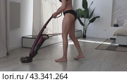 Woman in underwear tidies up room using vacuum cleaner. Стоковое видео, видеограф Владимир Григорьев / Фотобанк Лори