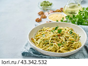 Pesto pasta bavette with walnuts, parsley, garlic, nuts, olive oil. Side view. Стоковое фото, фотограф Natalia Gdovskaia / Фотобанк Лори