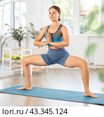Young girl performing Utkata Konasana with hands in namaste. Стоковое фото, фотограф Яков Филимонов / Фотобанк Лори