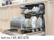 The dishwasher in the kitchen is specifically designed to securely accommodate plates and bowls. Стоковое AI-изображение, AI-художник Юрий Поздников / Фотобанк Лори
