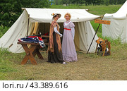 Historical reconstruction in beautiful historical and authentic costumes at festival Times and Epochs in Moscow. Ladies visiting Belarusian Hussar Regiment (2024 год). Редакционное фото, фотограф Валерия Попова / Фотобанк Лори