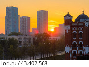 Красивый утренний городской пейзаж. Восход солнца над жилым кварталом. Вид на многоэтажные дома. На переднем плане красивое историческое здание. Город Екатеринбург, Свердловская область, Россия. Стоковое фото, фотограф Андрей Степанов / Фотобанк Лори
