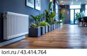 White Radiator in Modern Office Hallway With Plants and Hardwood Flooring. Стоковое AI-изображение, AI-художник Сергей Толмачёв / Фотобанк Лори
