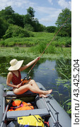 A girl with a fishing rod in her hands. Girl on fishing. A girl in a boat catches fish. (2010 год). Редакционное фото, фотограф Zima Nadezhda / Фотобанк Лори